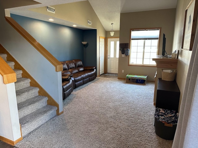 living room featuring visible vents, baseboards, stairway, lofted ceiling, and carpet flooring