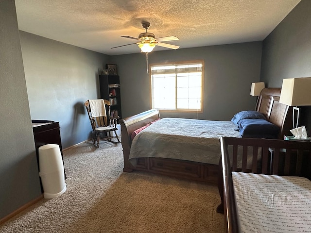 bedroom featuring a textured ceiling, ceiling fan, and carpet floors