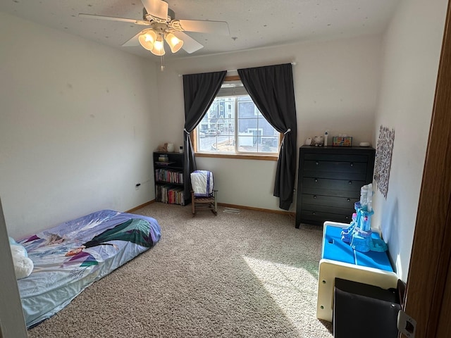 carpeted bedroom featuring a ceiling fan and baseboards