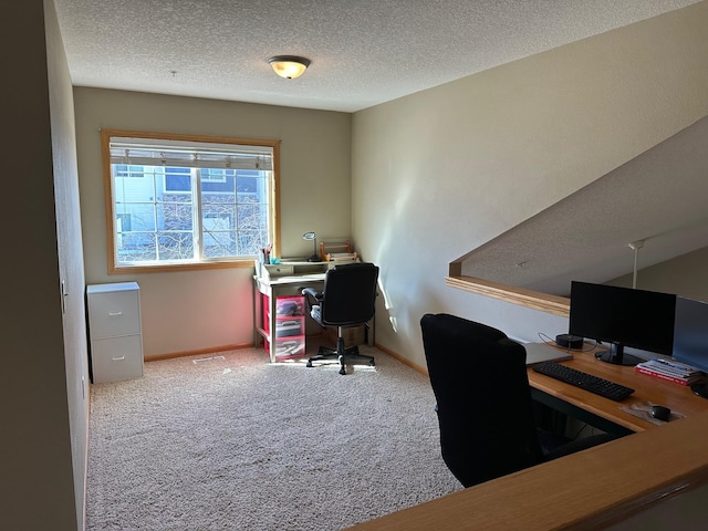 office area featuring a textured ceiling, baseboards, and carpet floors