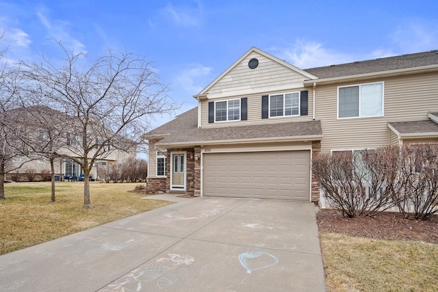 view of front of home with an attached garage, concrete driveway, a front lawn, and a shingled roof