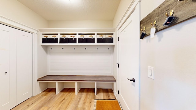 mudroom featuring a textured ceiling and wood finished floors