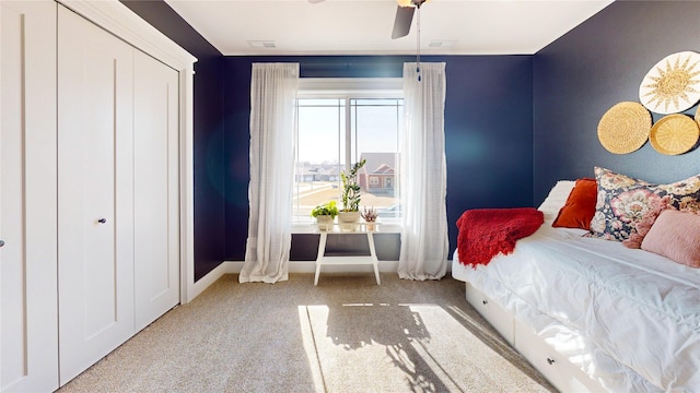 carpeted bedroom featuring baseboards, visible vents, and ceiling fan