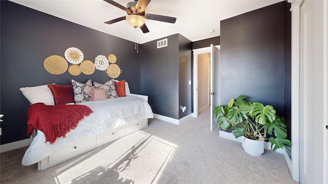 carpeted bedroom with visible vents, baseboards, and ceiling fan