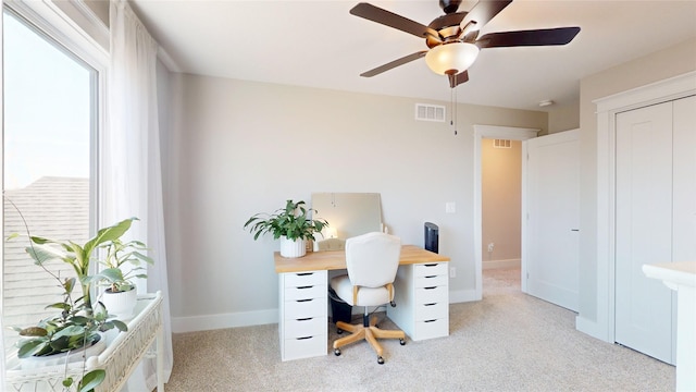 home office with visible vents, baseboards, a healthy amount of sunlight, and ceiling fan