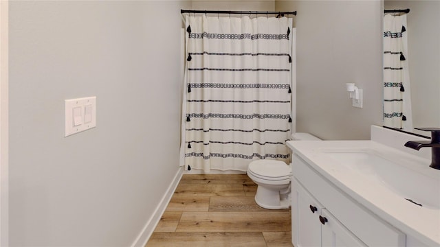 full bath featuring a shower with curtain, toilet, wood finished floors, and vanity