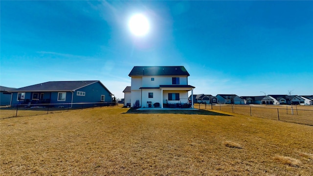 back of property featuring a patio area, a fenced backyard, and a yard