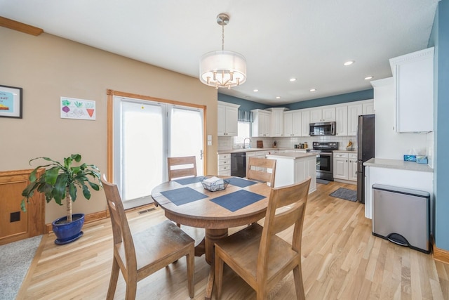 dining space featuring light wood-type flooring, visible vents, a notable chandelier, and recessed lighting