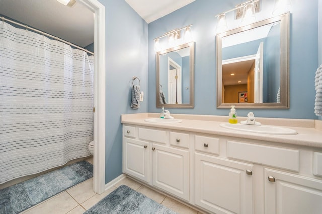 full bath featuring a sink, toilet, double vanity, and tile patterned floors