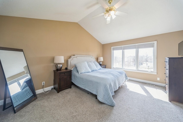 bedroom with a ceiling fan, vaulted ceiling, light colored carpet, and baseboards