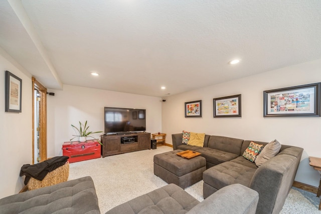 carpeted living area with recessed lighting and baseboards