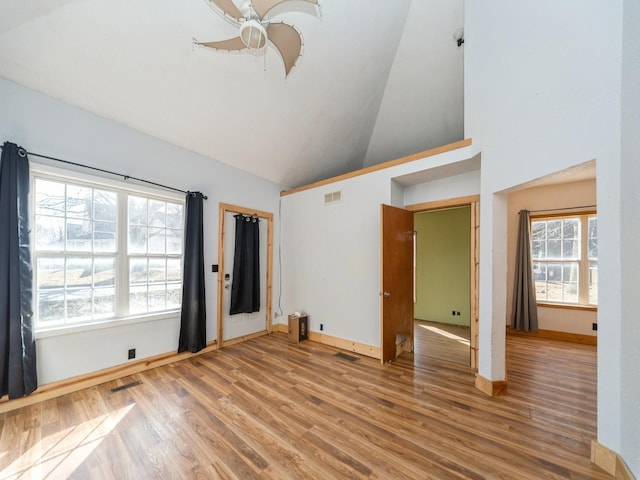 interior space featuring visible vents, a ceiling fan, and wood finished floors