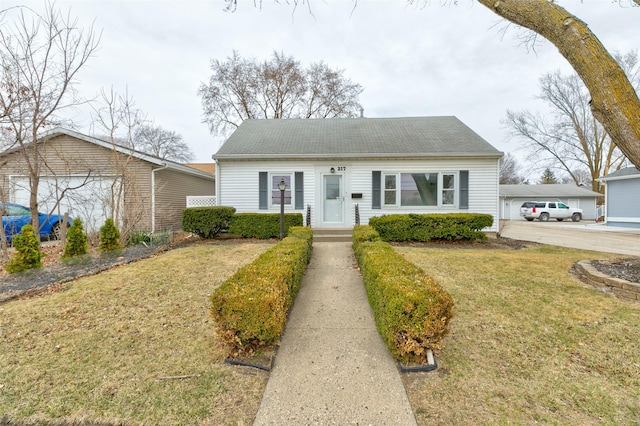 view of front of property with a front yard and a garage