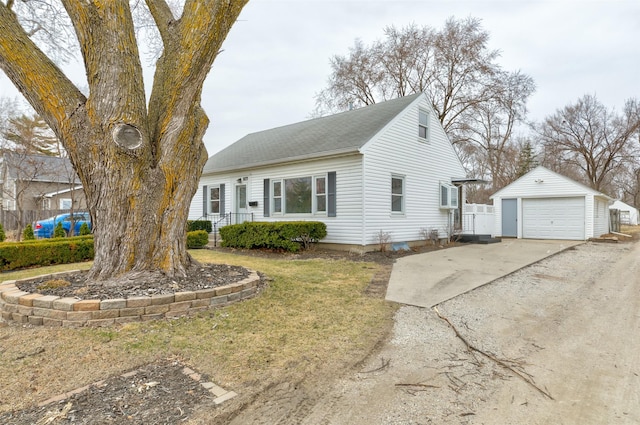 view of front of property featuring a garage, an outbuilding, roof with shingles, and concrete driveway