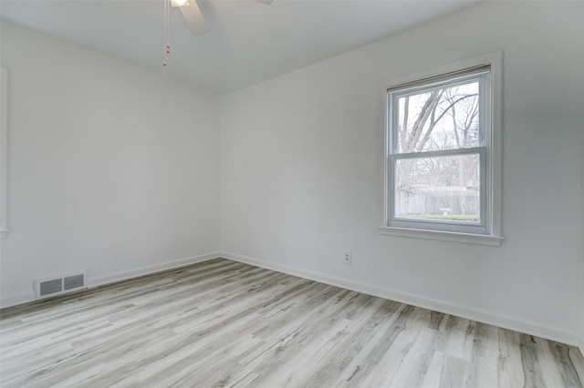 spare room with visible vents, baseboards, light wood-style floors, and ceiling fan