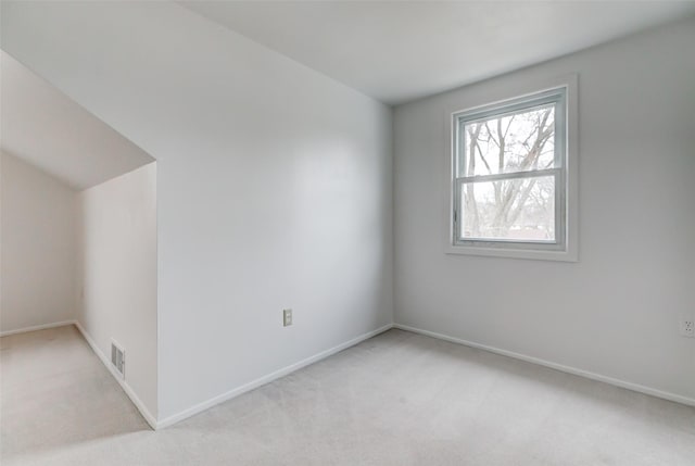 bonus room with light colored carpet, visible vents, and baseboards