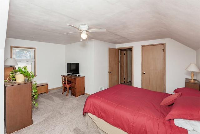 carpeted bedroom featuring a ceiling fan, baseboards, visible vents, vaulted ceiling, and a textured ceiling