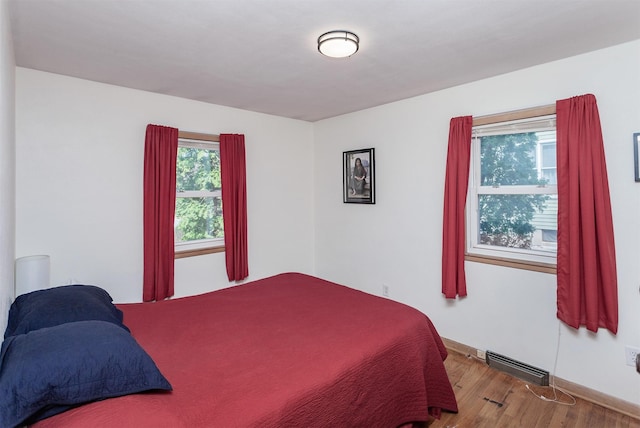 bedroom with wood finished floors and visible vents