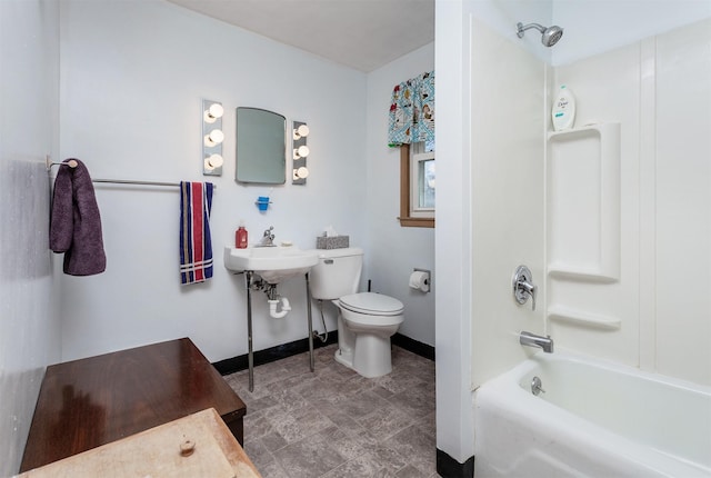 bathroom with toilet, shower / bath combination, and baseboards