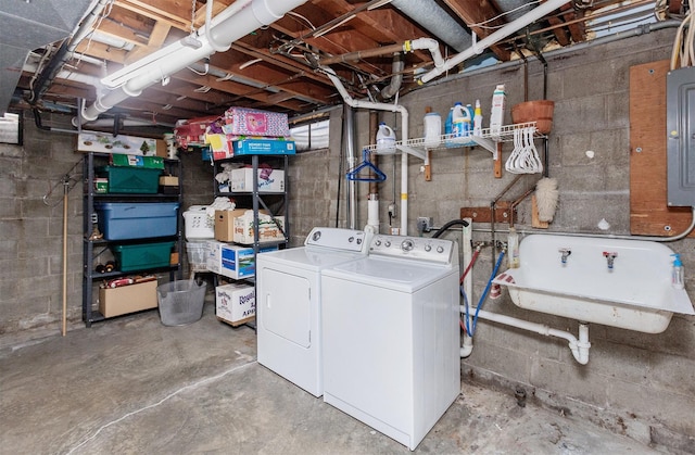 washroom with a sink, electric panel, independent washer and dryer, and laundry area