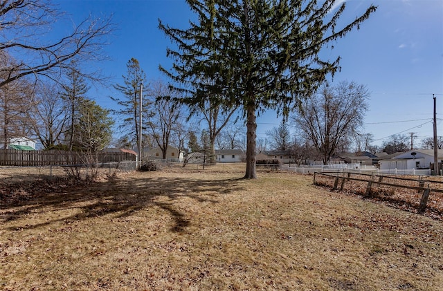 view of yard with a residential view and fence