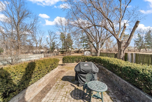 view of patio with a grill and a fenced backyard