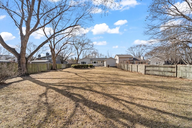 view of yard with a residential view and a fenced backyard