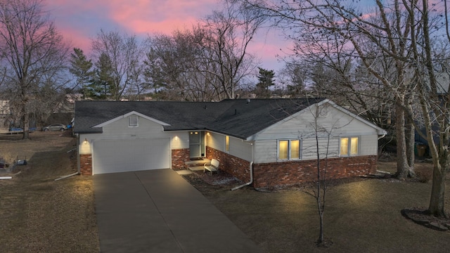 ranch-style home featuring brick siding, concrete driveway, a garage, and a shingled roof