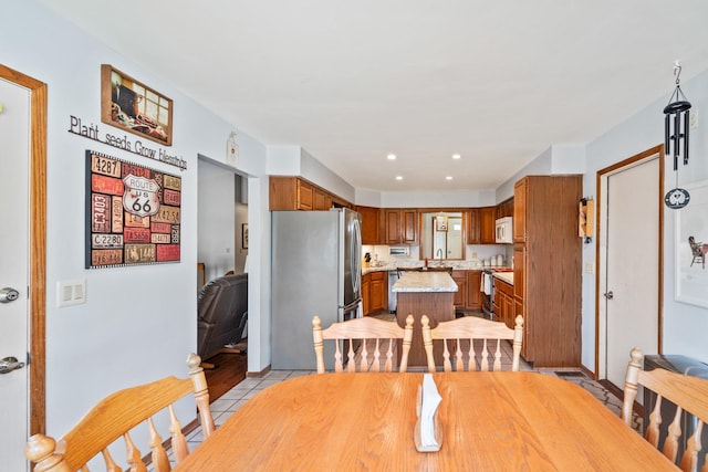 dining room featuring light tile patterned floors and recessed lighting