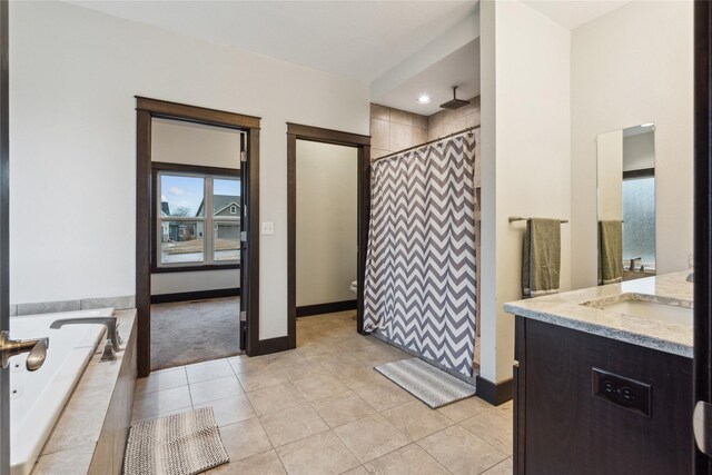 full bathroom with a garden tub, a shower with curtain, vanity, and tile patterned flooring