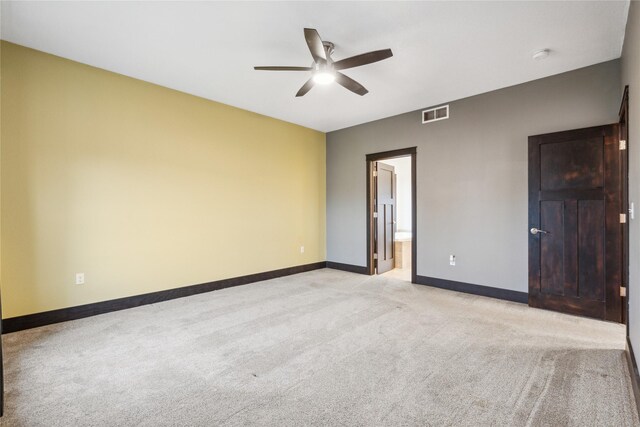 empty room with visible vents, baseboards, light colored carpet, and ceiling fan