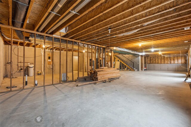 unfinished basement featuring stairs