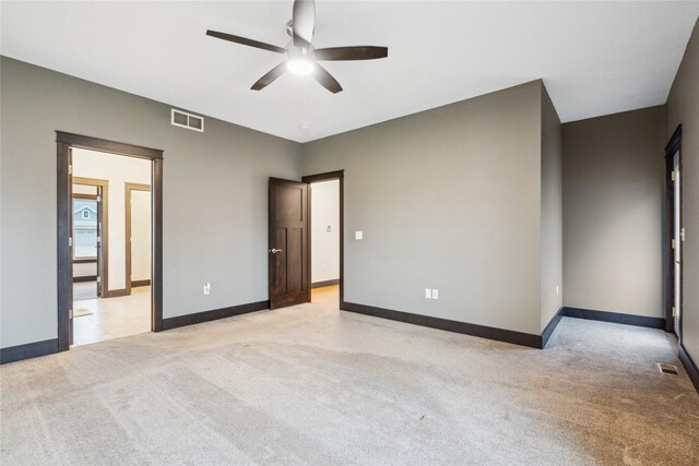 unfurnished bedroom featuring baseboards, visible vents, and light carpet