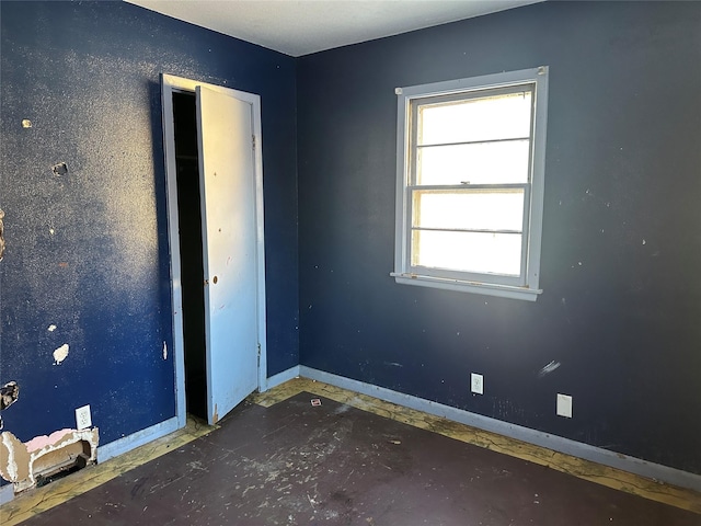 spare room with baseboards