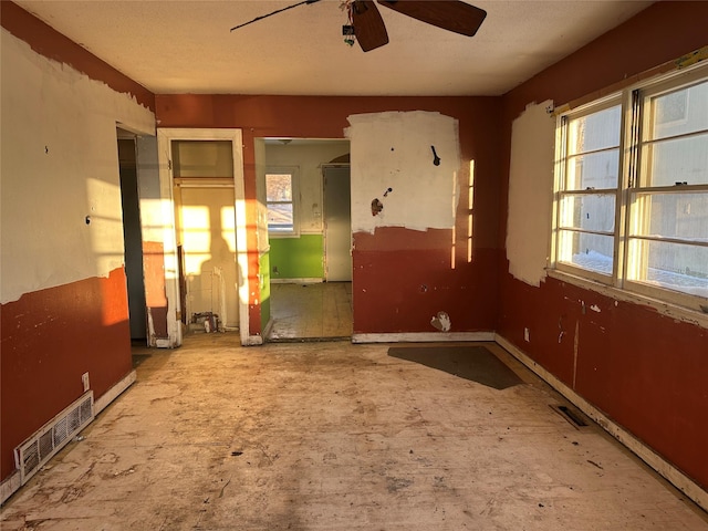 empty room with a ceiling fan and visible vents