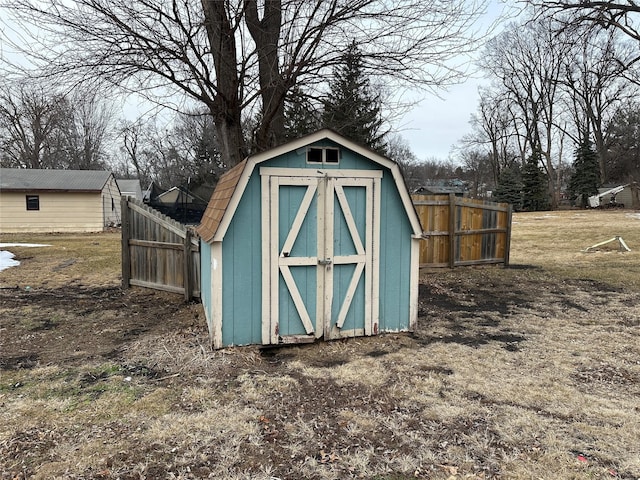 view of shed featuring fence