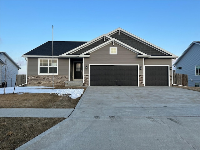 craftsman inspired home with driveway, a garage, and fence