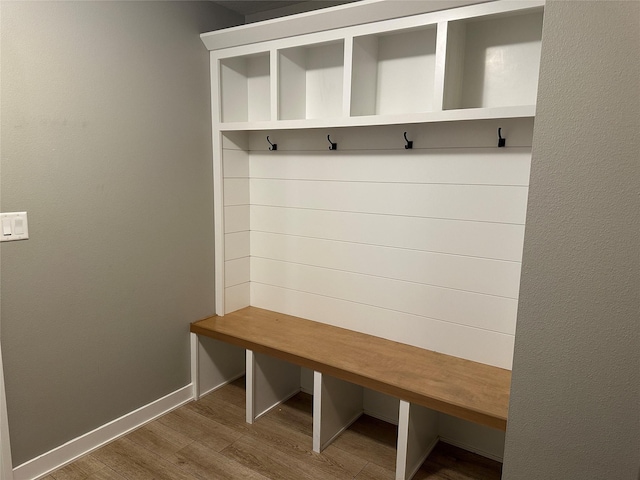 mudroom with baseboards and wood finished floors