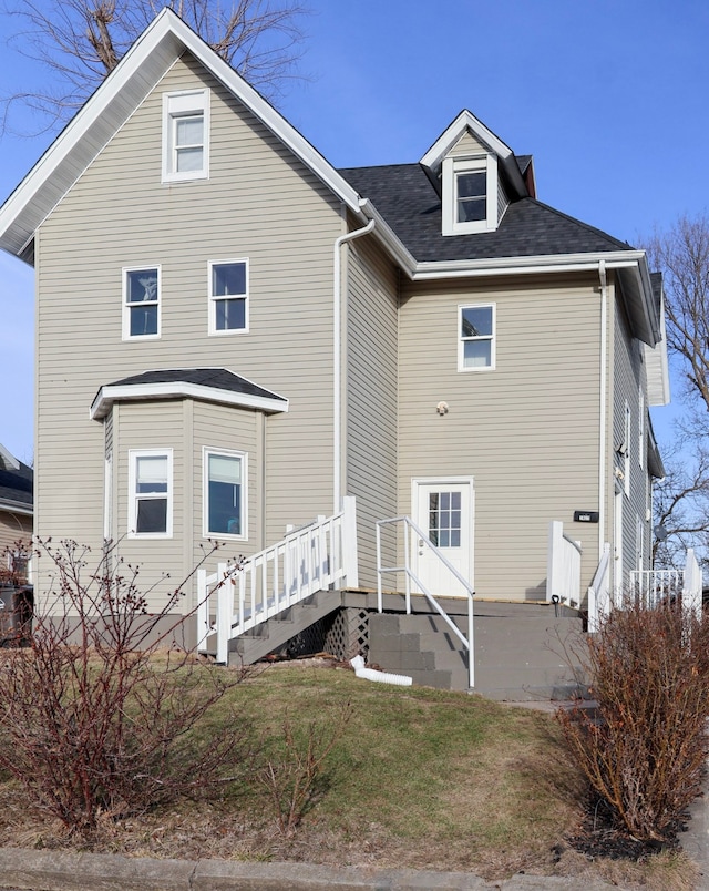 back of house with a yard and central AC