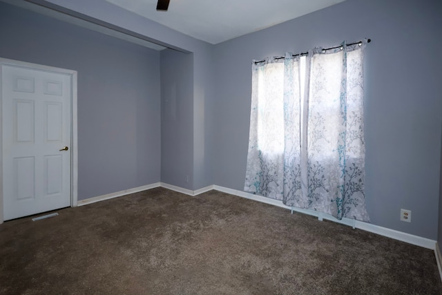 empty room featuring baseboards, carpet, and a ceiling fan