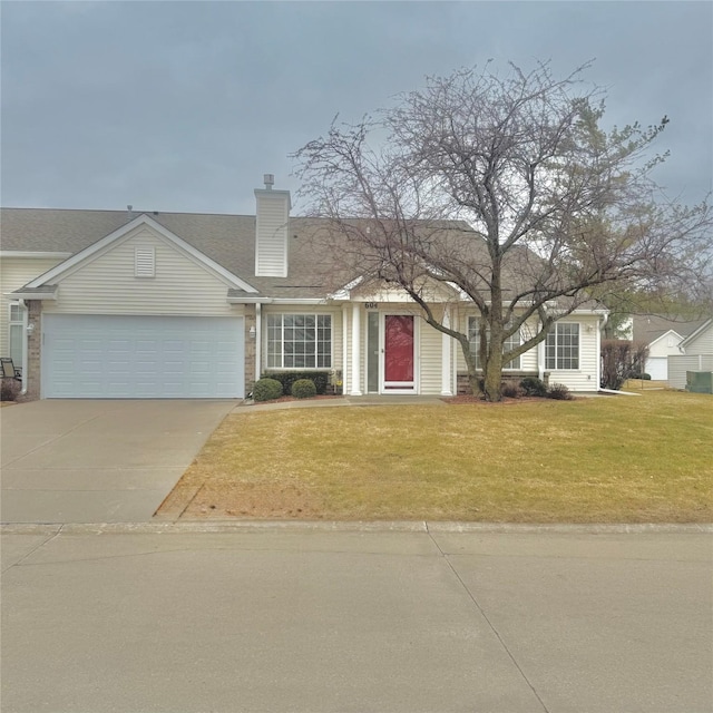 view of front of home with a front yard, concrete driveway, an attached garage, and a chimney