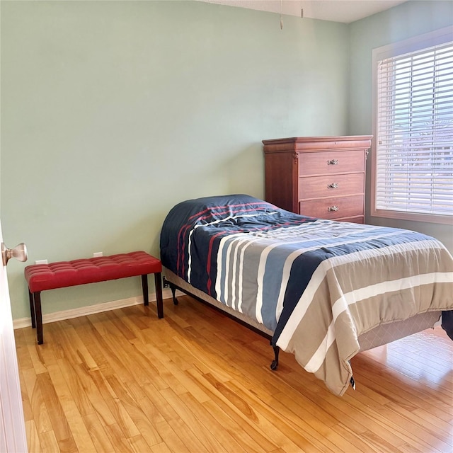 bedroom featuring baseboards and light wood-style floors