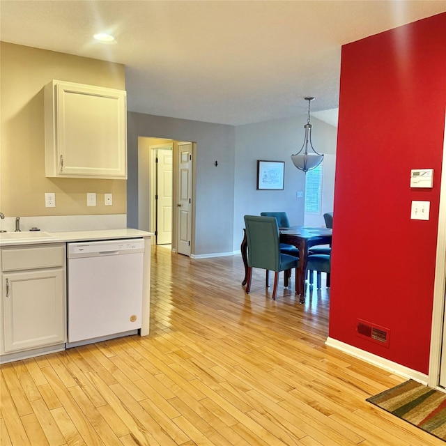 kitchen featuring visible vents, a sink, light countertops, white cabinets, and dishwasher