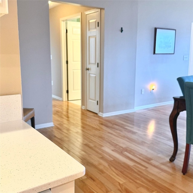 interior space featuring light wood-style flooring and baseboards