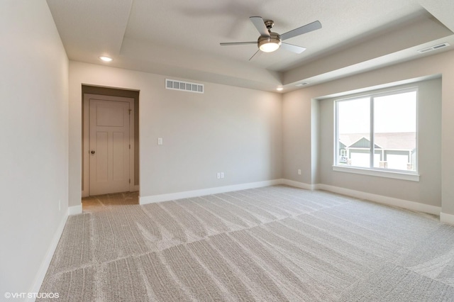 136 Creekside Dr, Bondurant, IA 50035 - unfurnished room with a raised ceiling, light carpet, ceiling fan, and recessed lighting