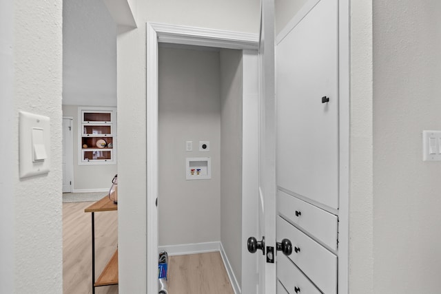 clothes washing area featuring baseboards, light wood-type flooring, laundry area, hookup for a washing machine, and hookup for an electric dryer