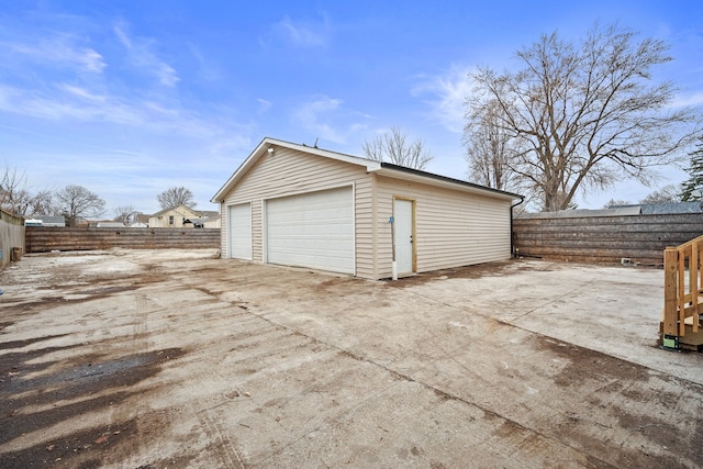 detached garage featuring fence