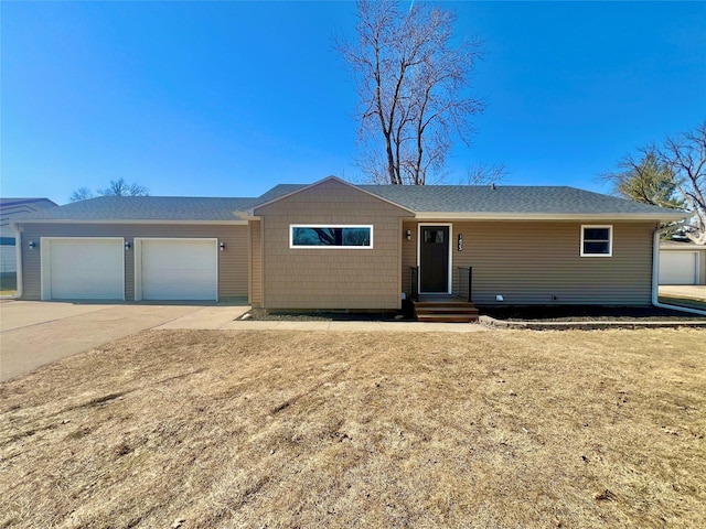 single story home featuring concrete driveway and an attached garage