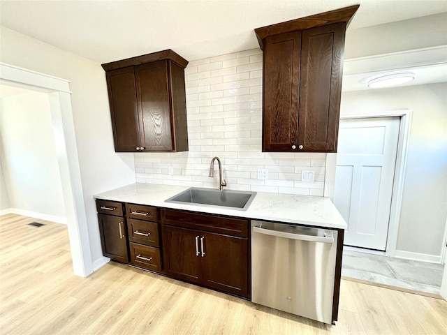 kitchen with light wood-style flooring, a sink, backsplash, dark brown cabinetry, and dishwasher