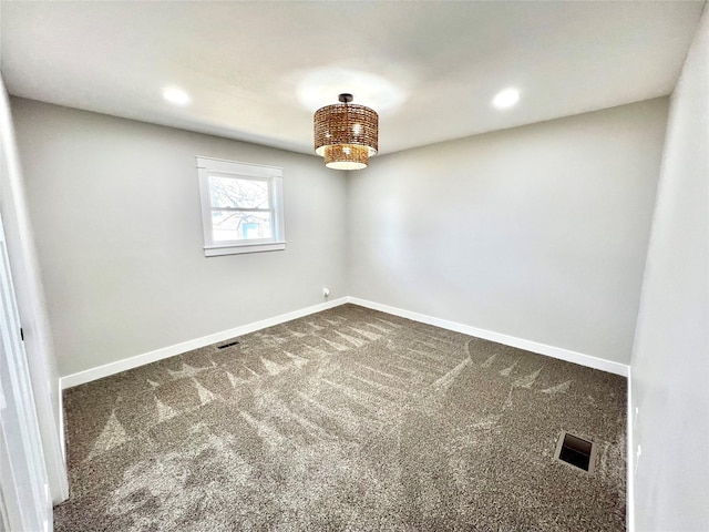 spare room featuring recessed lighting, dark colored carpet, visible vents, and baseboards